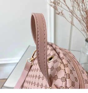 Close-up of pink printed handbag handle with premium stitching and gold hardware