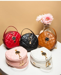 Group display of mini round quilted bags with cat charm in five vibrant colors