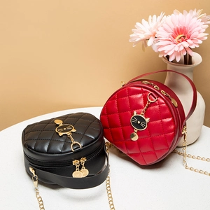 Quilted round mini bags in black and red with cat pendants and gold chain straps