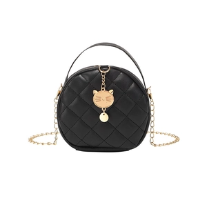 Black quilted round mini bag with gold cat charm and chain strap on white background