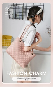Detailed view of pink quilted leather tote bag with large metal ring buckle and stitching