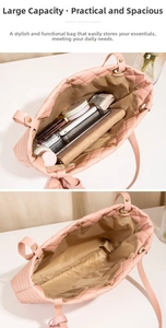 Detail showing the large capacity of this light pink quilted tote bag with everyday items