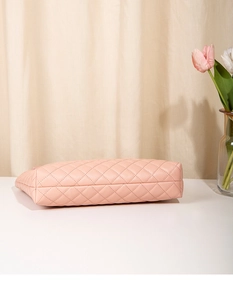 Detailed view of pink quilted handbag bottom with high-quality diamond stitching
