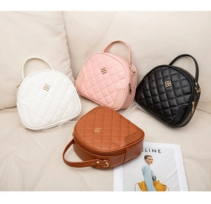Close-up of quilted PU leather crossbody bags in white pink black and brown tones