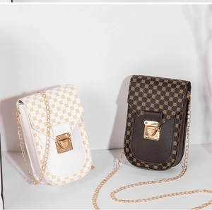 Detail of vintage geometric pattern phone bags with gold chain straps and metal locks