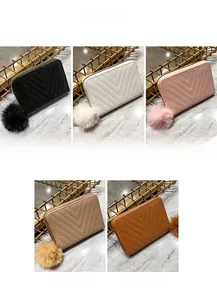Quilted women's coin purses with plush pompom charms in black, white, pink, khaki and brown