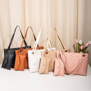 Five colors of quilted faux leather tote bags with matching zipper pouches and gold hardware