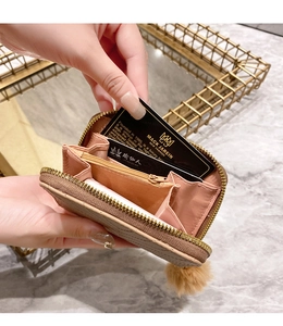 Detailed interior view of a quilted short wallet with card slots and plush ball charm