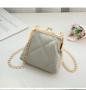 Detail of light grey PU leather mini crossbody bag with diamond quilted stitching and gold clasp