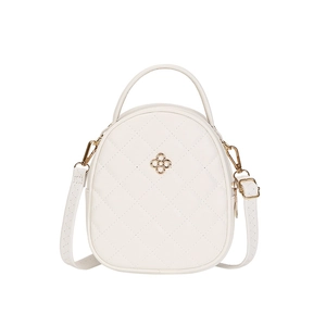 Minimalist white quilted mini backpack with gold hardware and adjustable crossbody straps