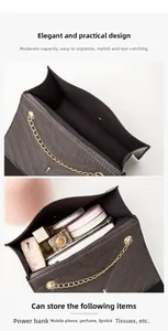 Detail view of the black crossbody bag showing its interior space and storage capacity