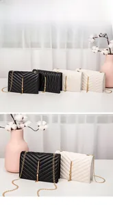 Detail of quilted chain shoulder bags with metallic tassels in black and white leather