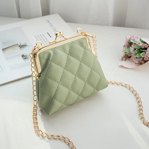 Pale green quilted mini crossbody bag with gold chain strap and vintage metal clasp