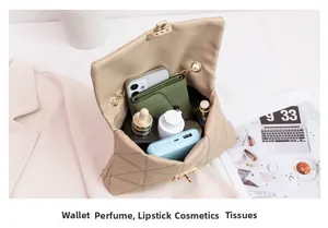 Interior view showing the large capacity of a quilted chain bag with various accessories