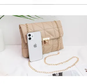 Detailed comparison showing the small beige quilted chain bag size next to a smartphone