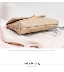 Detail view of beige quilted crossbody bag with golden twist-lock and structured bottom