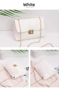 Detailed close-up of white quilted crossbody bag with gold metal chain and twist lock