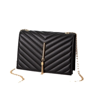Elegant black chevron quilted shoulder bag with gold chain and tassel pendant detail