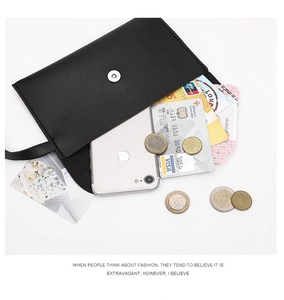 Detail view of black envelope crossbody bag with internal slots for phone and cards