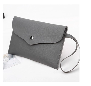 Detail of gray envelope clutch bag with cross-grain texture and silver metal snap button