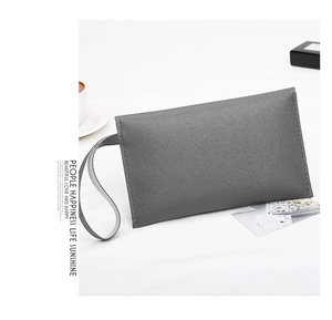 Macro detail of grey nappa texture envelope clutch bag with slim wristlet strap