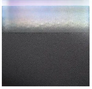 Close-up of black litchi grain leather texture on a minimalist portable mobile phone bag