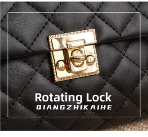 Detail of black quilted leather handbag featuring a golden twist lock closure mechanism