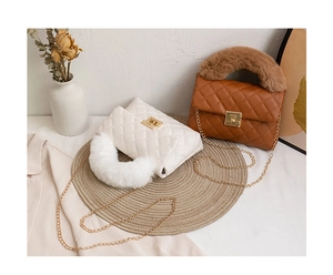 Detail of quilted mini crossbody bags with plush faux fur handles in white and brown