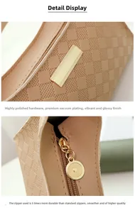 Detail of high-polished gold hardware and smooth zipper on embossed beige shoulder bag