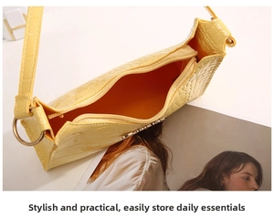 Top view of yellow crocodile pattern underarm bag showing interior storage and zip closure
