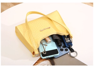 Interior view of yellow crocodile pattern shoulder bag showing storage for daily items