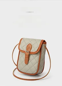 Detail of quilted rhombic texture and contrast color stitching on the crossbody phone bag