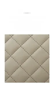 Close-up of beige quilted rhombic texture fabric with high-quality stitching detail