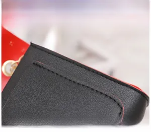 Detail showing high-quality double stitching on the black and red leather shoulder bag