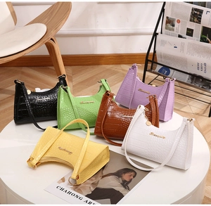 Detailed view of six faux crocodile leather HOBO underarm bags in various bright colors