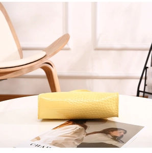 Detail shot of bright yellow crocodile embossed leather texture on the HOBO bag bottom