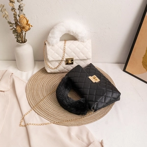 Quilted crossbody bag with plush handles and gold twist lock in black and white