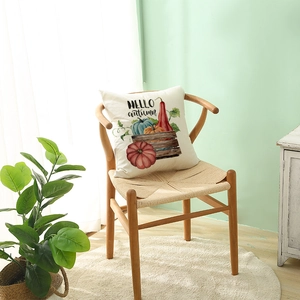 Hello Autumn pumpkin polyester pillow cover on a woven chair for cozy fall decor