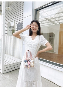 Close-up of PVC tote with daisy lace dress, woven liner and silk scarf detail