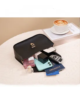 Detail view of mini shoulder bag interior showing storage space for phone and makeup