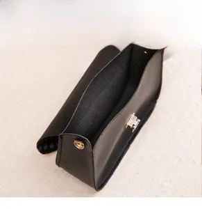 Detailed view of the spacious main compartment in this black leather mini crossbody bag