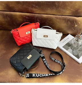 Detailed view of quilted leather bucket bags in red white and black with gold turn-locks