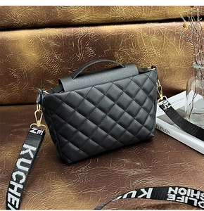 Detailed view of black quilted crossbody bag with wide logo-printed shoulder strap