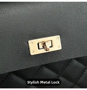 Macro detail of golden metal lock and quilted embroidery on black pebble leather bag