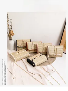 Detailed view of woven straw crossbody bags with metal tassels and gold chain straps