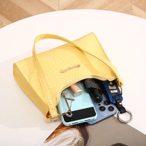 Yellow faux leather underarm bag with crocodile texture and metal Sunny City logo