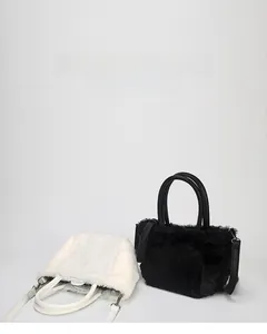 Detailed view of black and white plush quilted mini handbags with detachable shoulder straps
