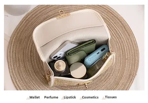 Detail view of woven square bag capacity showing phone, wallet, and cosmetics inside