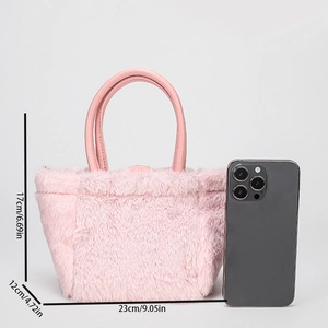 Pink faux fur handbag detail showing dimensions with smartphone for scale comparison
