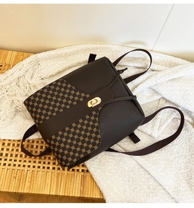 Detail of vintage brown mini crossbody bag with geometric pattern and gold twist lock